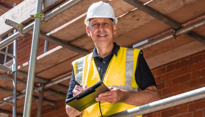 man inspecting scaffolding